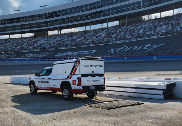 Toyota Tundra drying truck towing a FOD-Razor friction sweeper on a racetrack