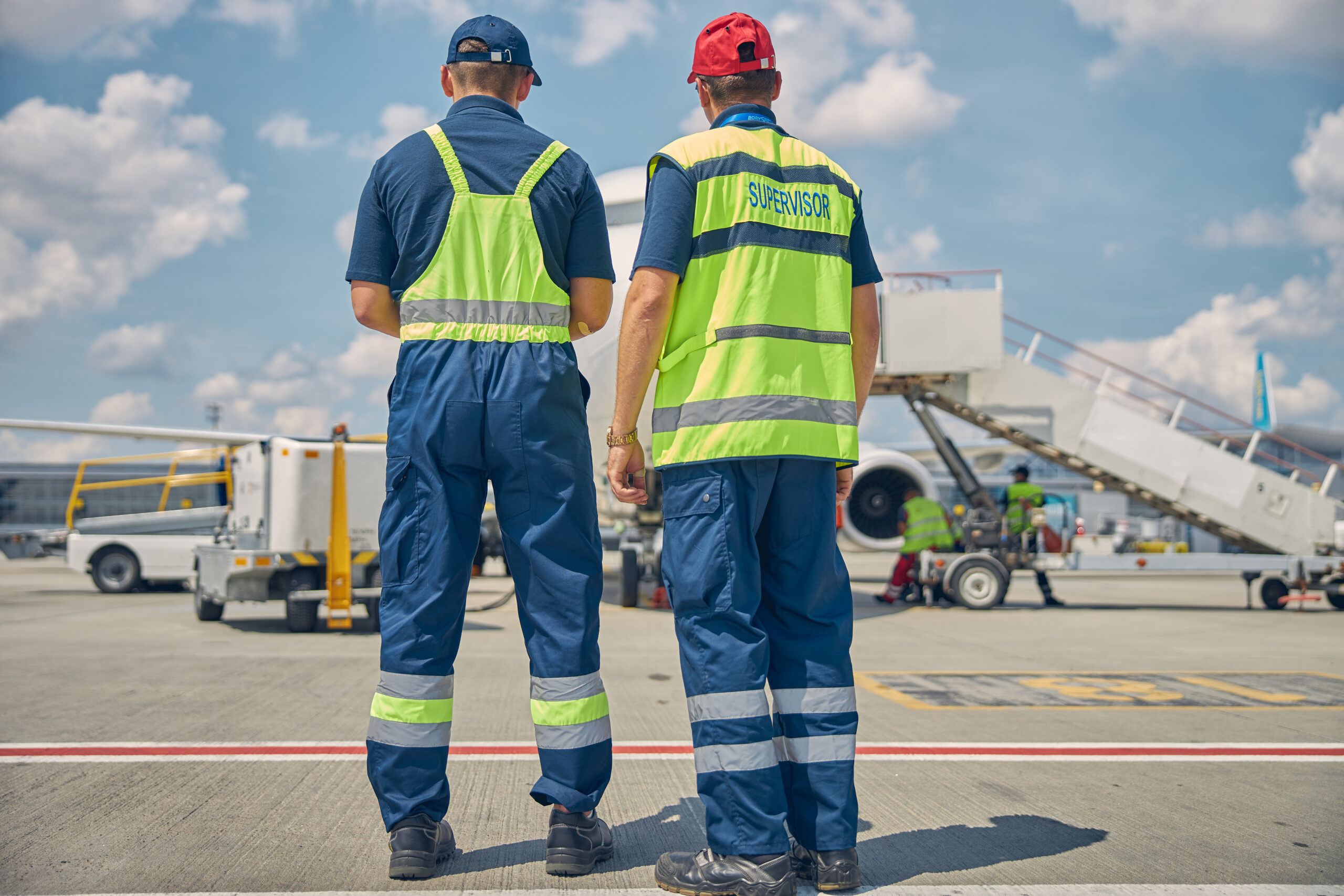 Two male technicians inspecting the ground equipment